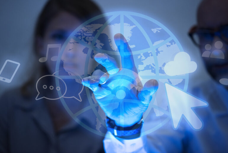 Two professionals interacting with a virtual interface of internet icons and a digital globe, representing global connectivity and data access, symbolic of concepts like static and rotating proxies used in web scraping.